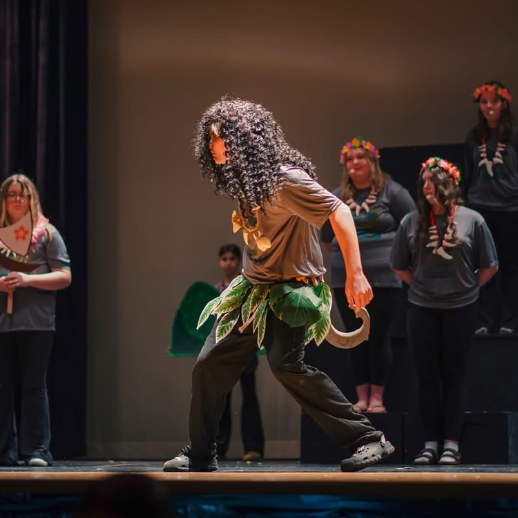 student on stage in costume