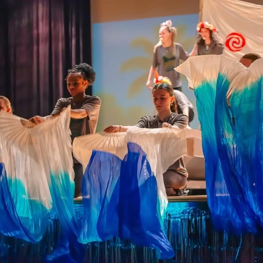 student on stage in costume