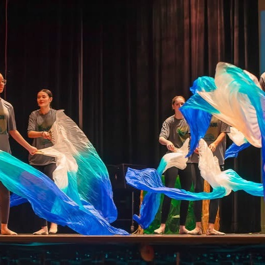 student on stage in costume