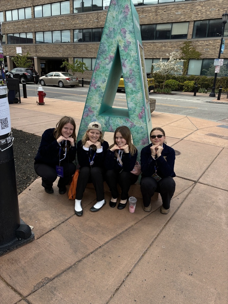 FFA students in front of a sculpture of the letter A