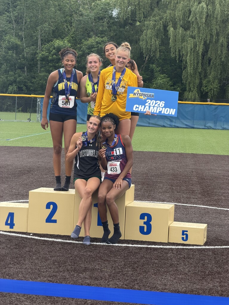 Group photo of runners at podium