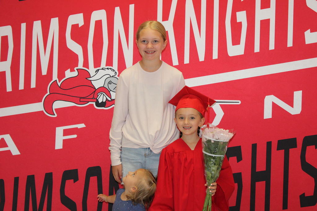 Afton students in front of Crimson Knight Banner
