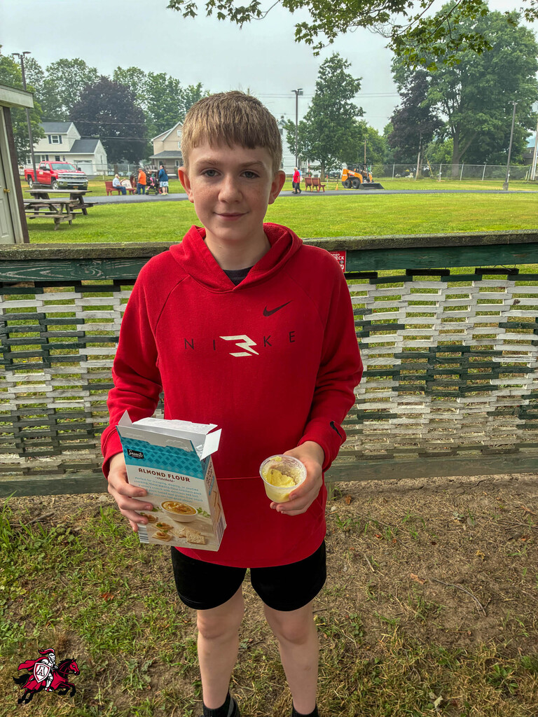 A student holds up a box of flour at Dairy Day at the Chenango County Fairgrounds