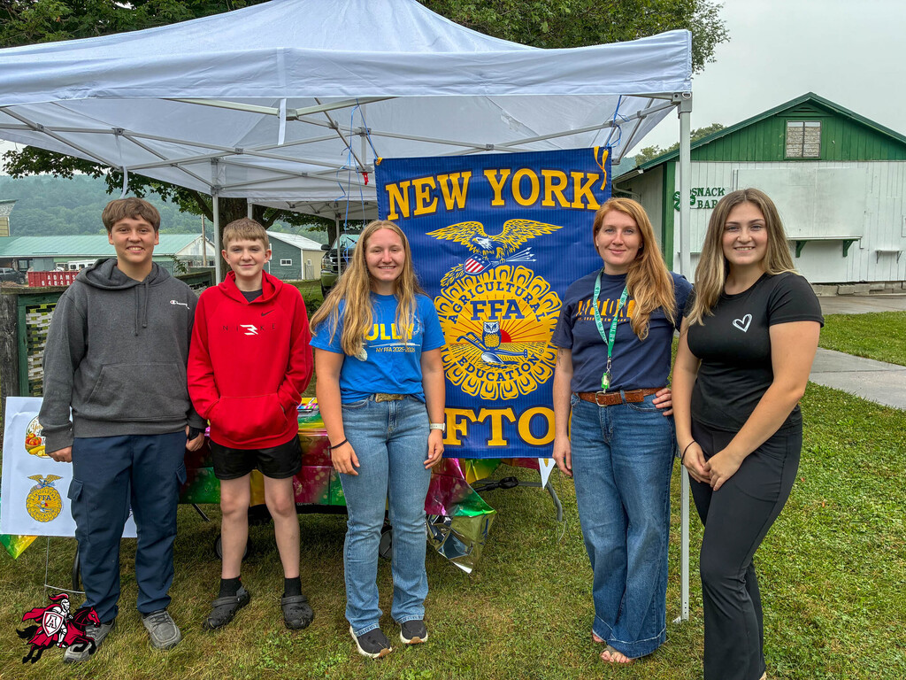 Afton FFA members stand in their booth at Dairy Day at the Chenango County Fairgrounds
