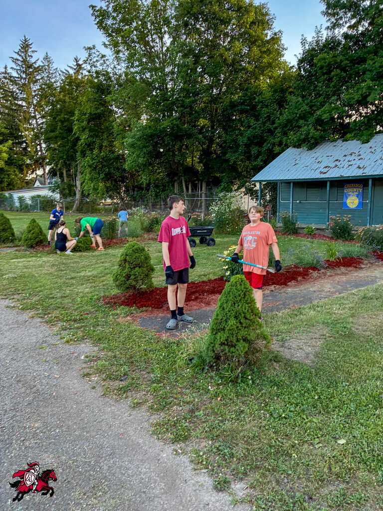 Afton FFA members mulch the community garden at the Chenango County Fairgrounds