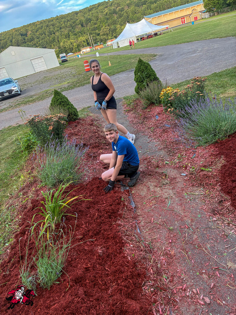 Afton FFA members mulch the community garden at the Chenango County Fairgrounds