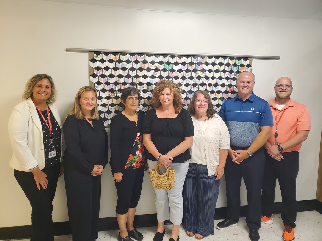 A group of Afton faculty and staff stand beside Bonnie Feltham after she is granted tenure