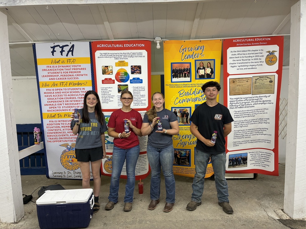 A group of Afton FFA members pose for photo in their booth at the Afton Fair