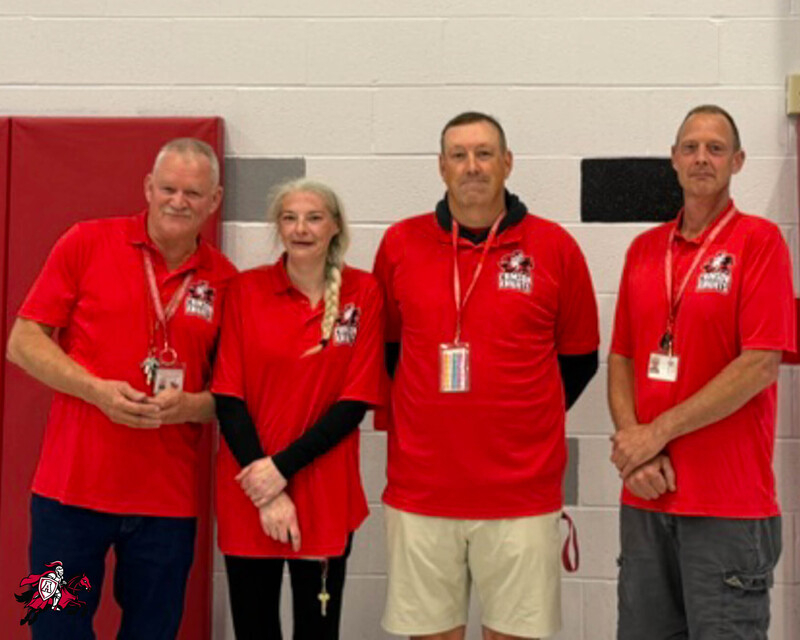 A group of Afton Central School District teachers, faculty and staff stand in a row and smile for a photo