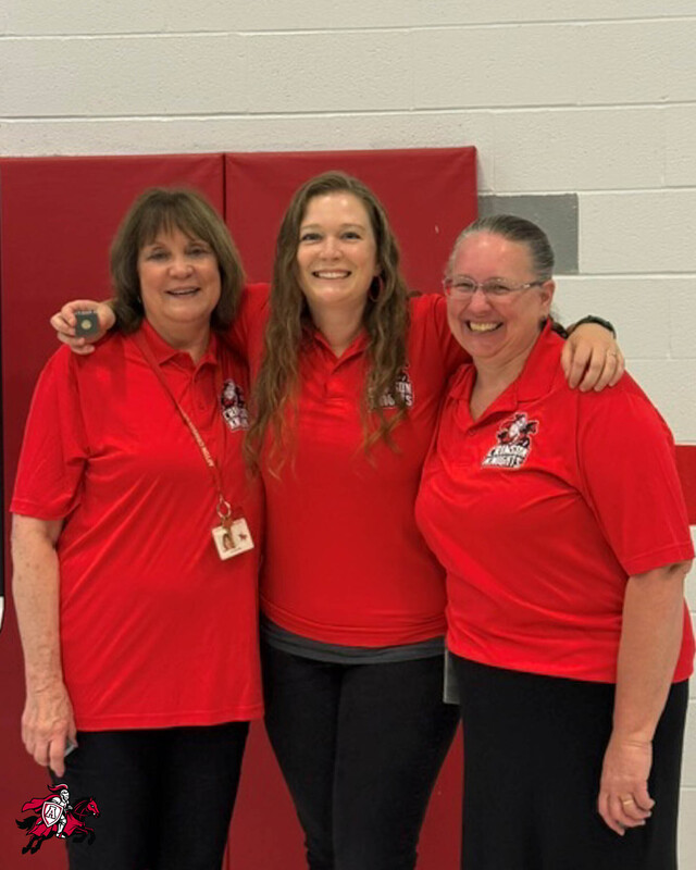 A group of Afton Central School District teachers, faculty and staff stand in a row and smile for a photo