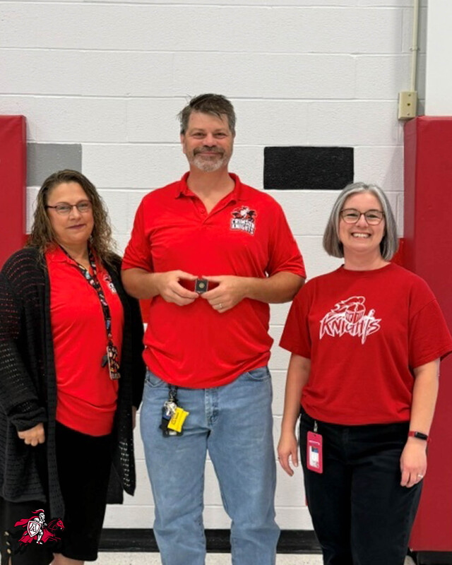 A group of Afton Central School District teachers, faculty and staff stand in a row and smile for a photo