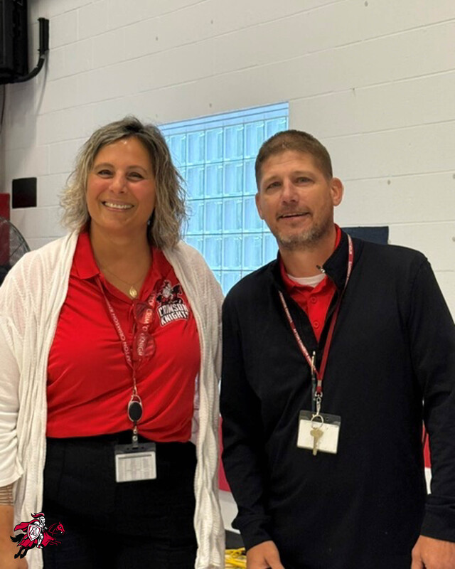 Two Afton Central School District employees stand beside each other and smile for a photo