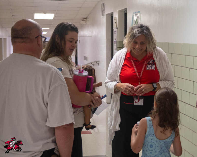 Afton Central School District students, families, teachers and staff have a conversation in the hallway of a school