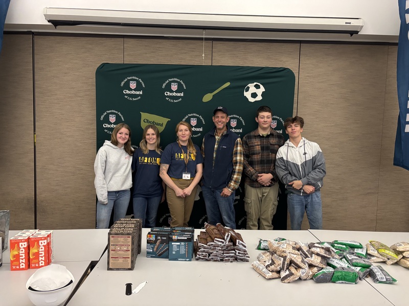 Afton FFA Advisor students and board president with piles of food
