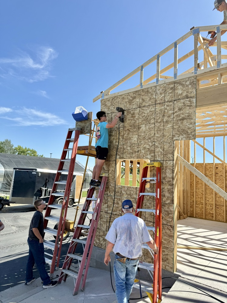 Putting up sheathing on a hot humid afternoon .