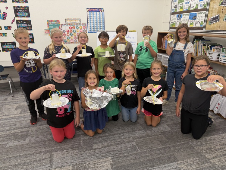Second Grade designing bird feeders in Science.