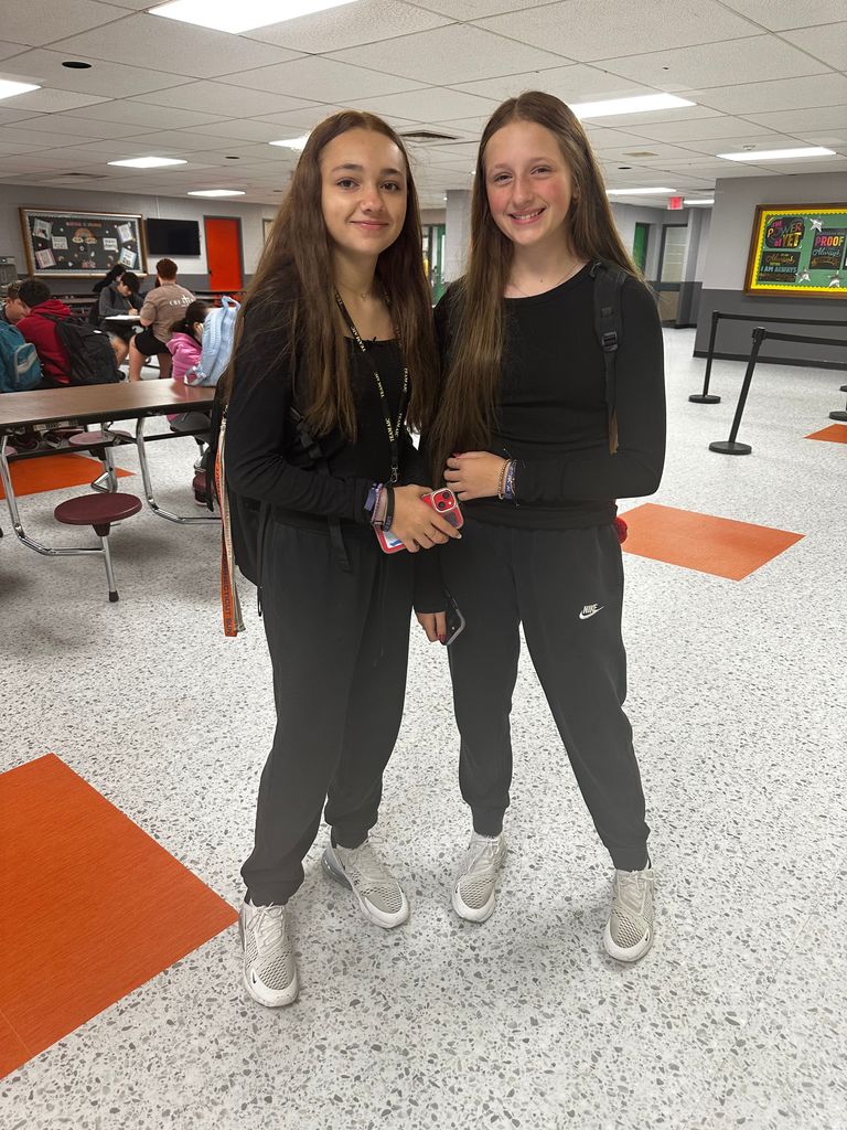 student wearing same outfit - all black gray sneakers