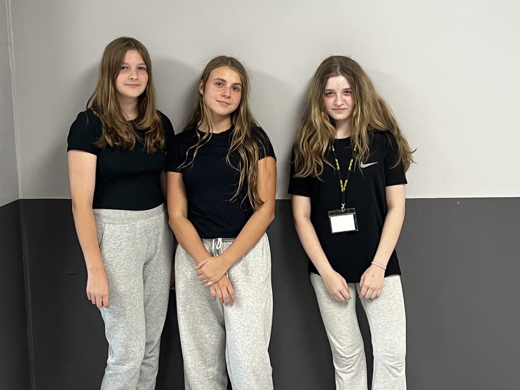 3 students matching gray sweatpants and black tshirts