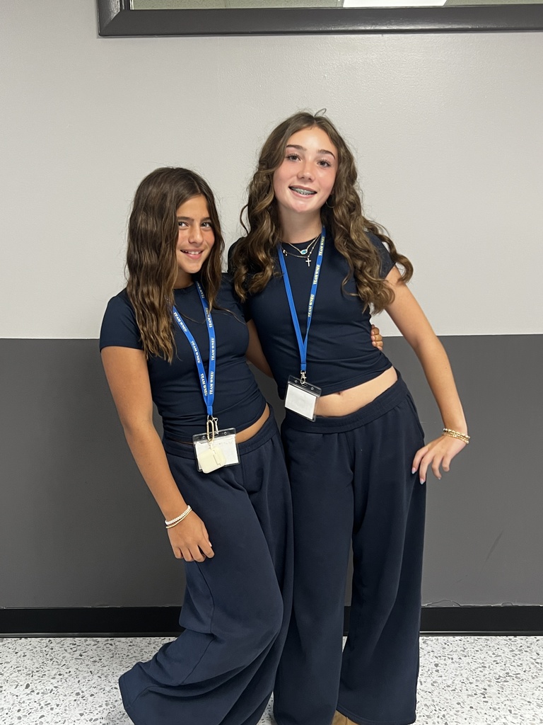 2 students wearing all blue