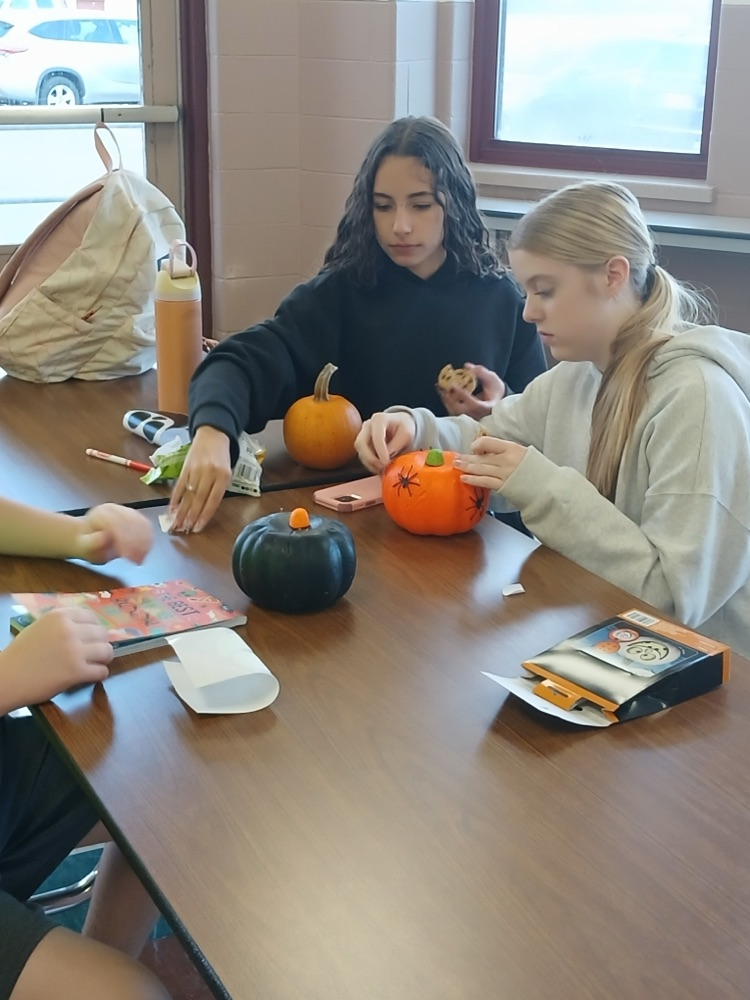 students at best buddies club meeting decorated pumpkins