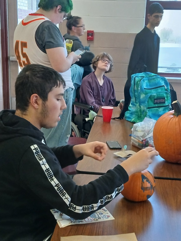 students at best buddies club meeting decorated pumpkins