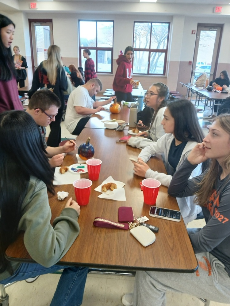 students at best buddies club meeting decorated pumpkins