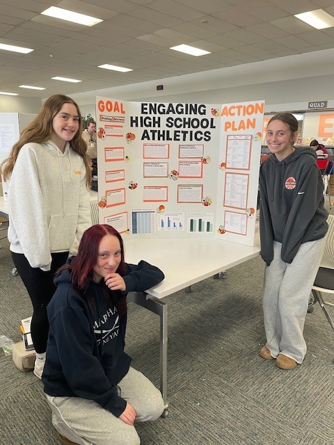 students standing with their completed civic posters