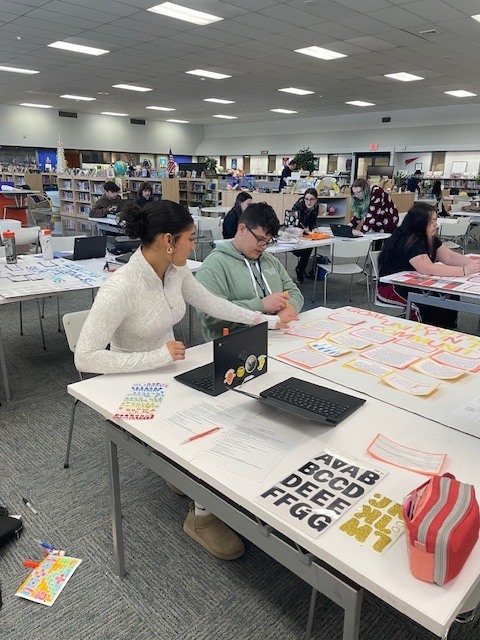 students standing with their completed civic posters