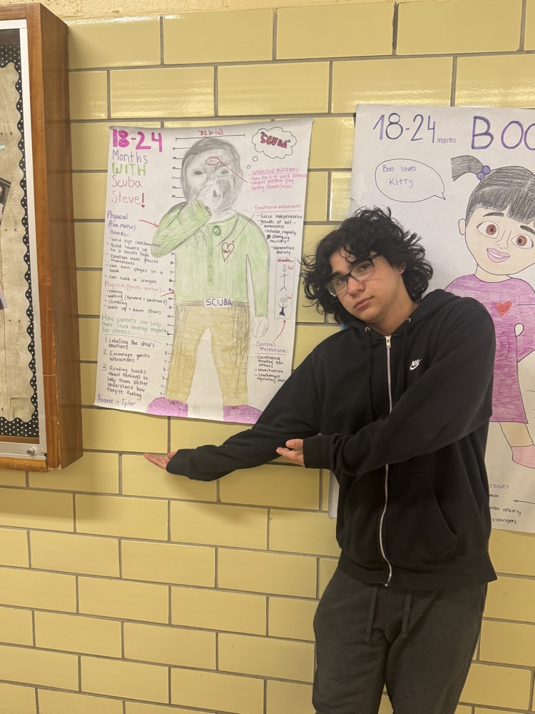 student in front of project