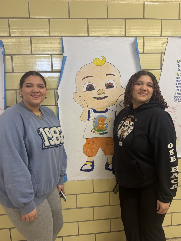 student in front of project