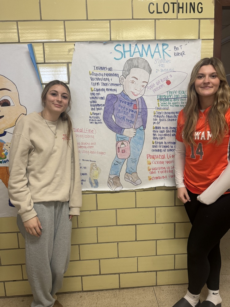 student in front of project