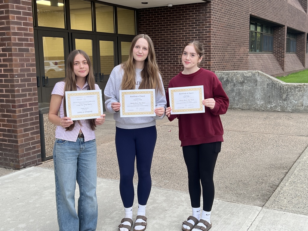 3 students holding award