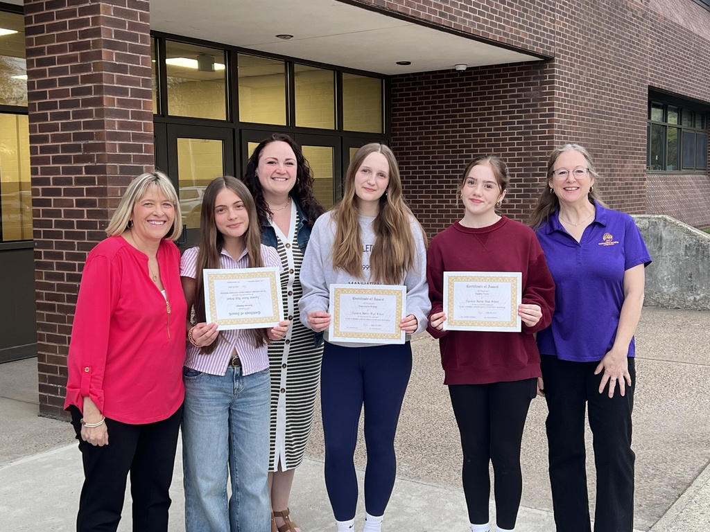 students and teachers posing with awards