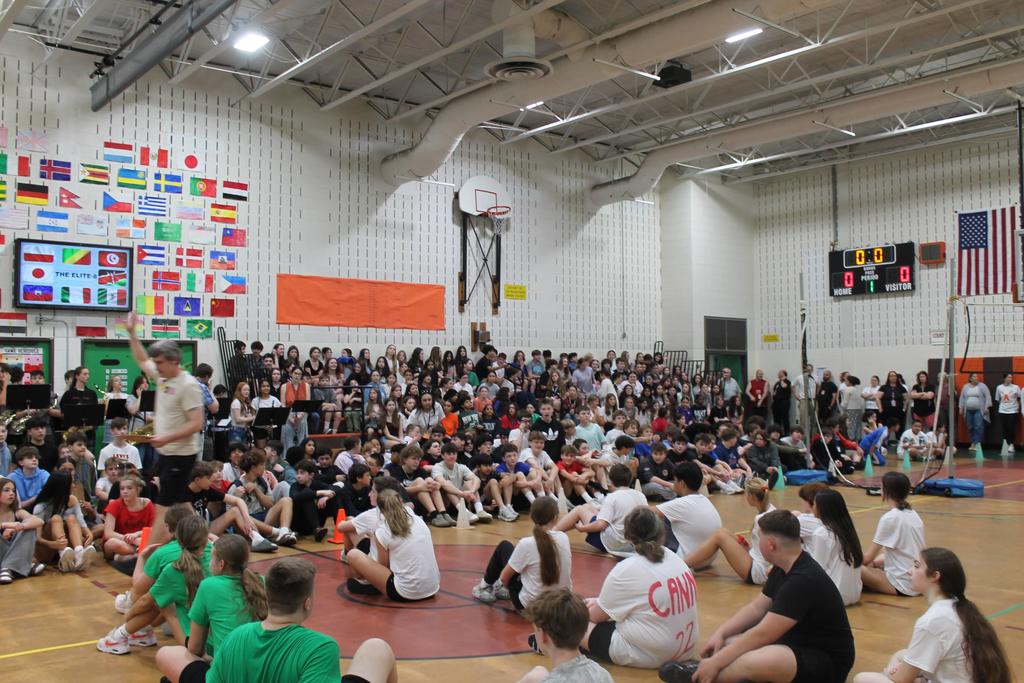 students ready to play volleyball and audience photo