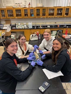 students sitting at science table