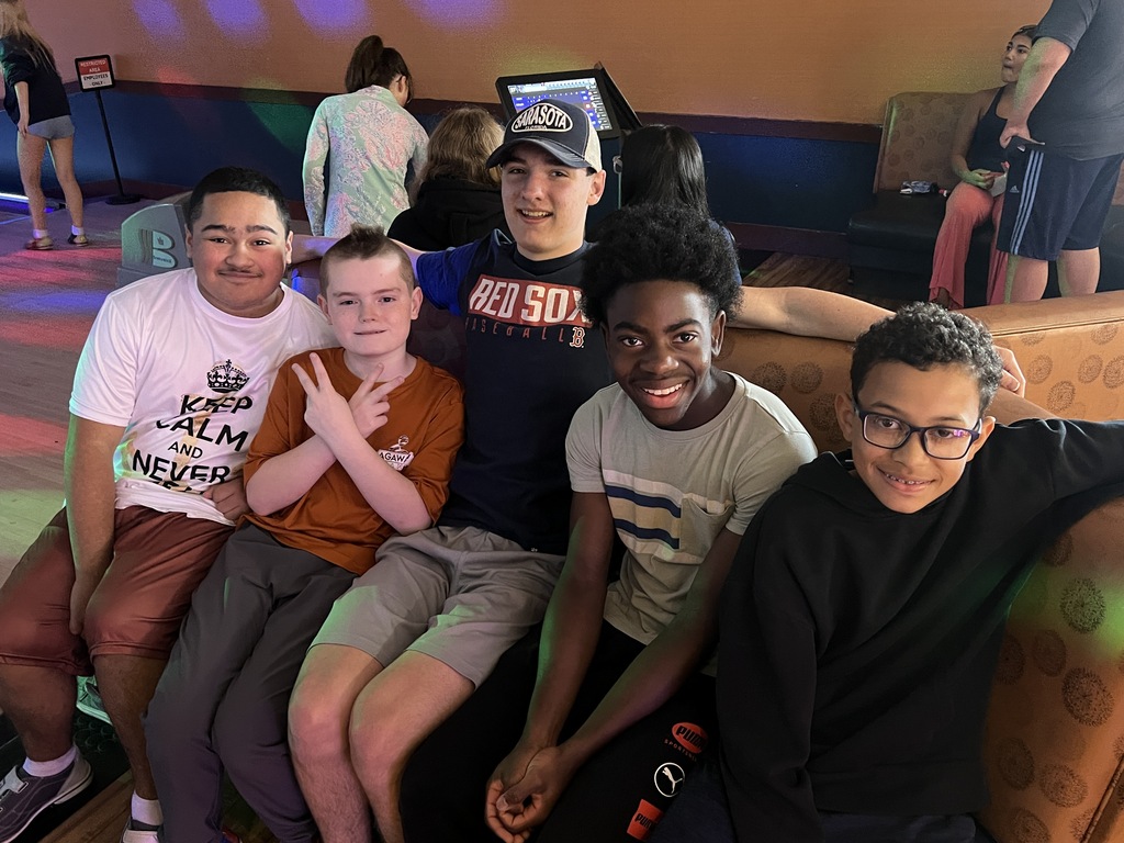 students posing in bowling alley