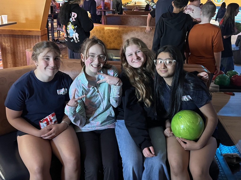 students posing in bowling alley