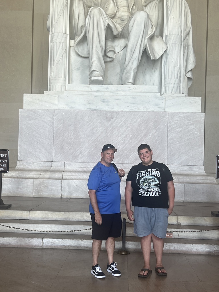 Principal and Student posing in front of Lincoln Memorial
