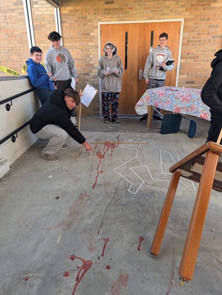 students in forensics science class examining a fake crime scene in the hallway