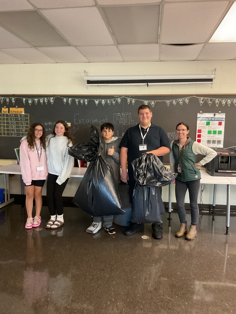 students and advisor getting ready to clean up school grounds
