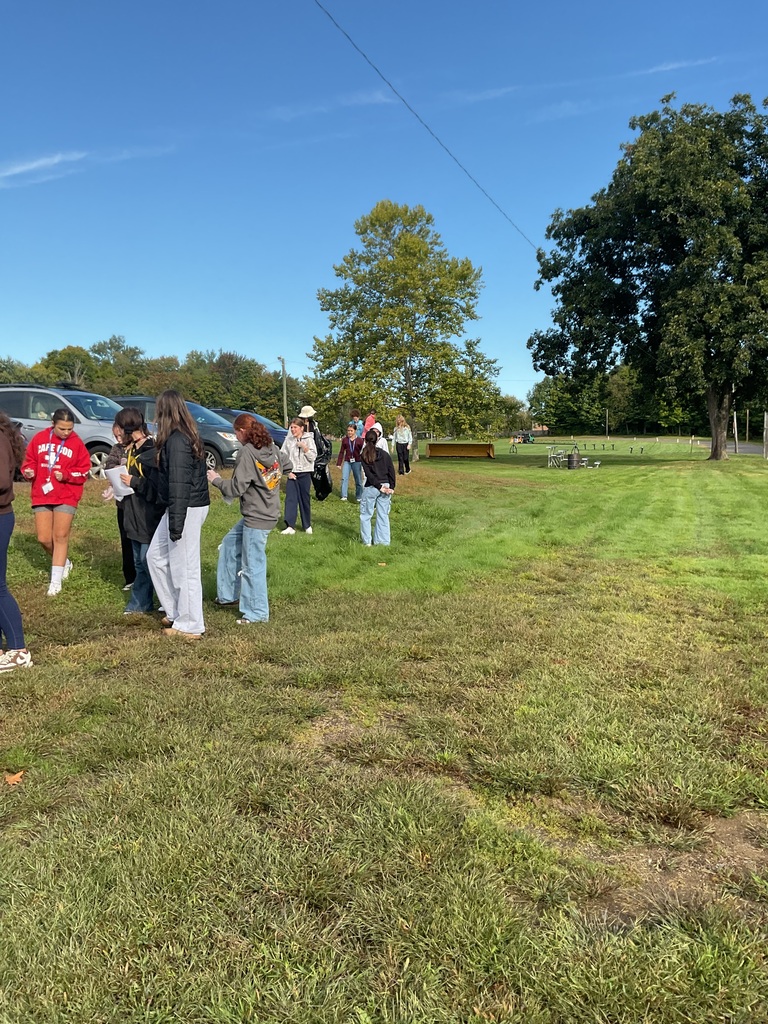 students outside picking up trash