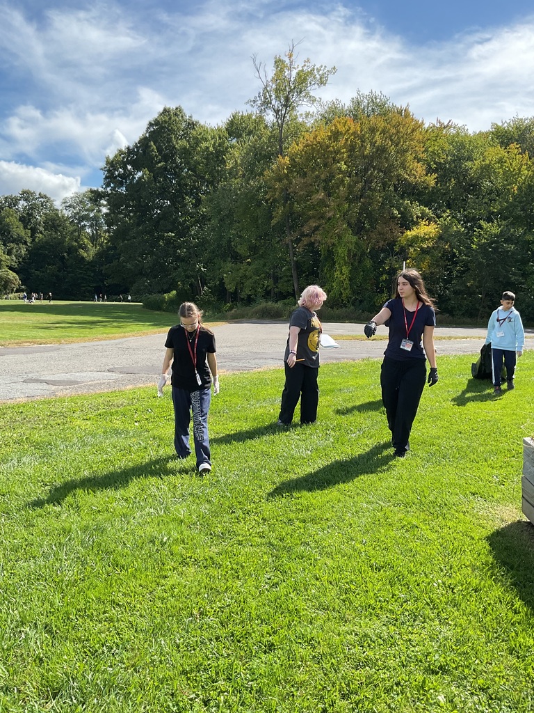 students outside picking up trash