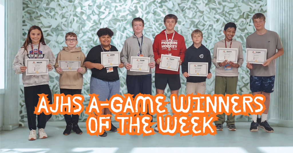 8 students posing with award of "A Game" Winner of the week award