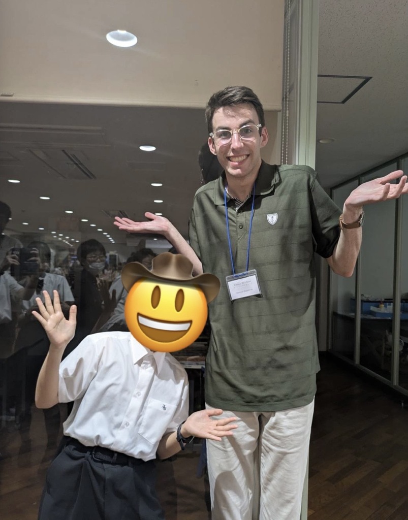 two people side by side shrugging, person on left is significantly taller than person on right