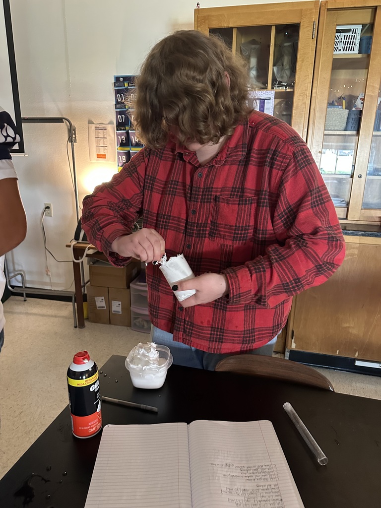 Student mixing slime in a beaker