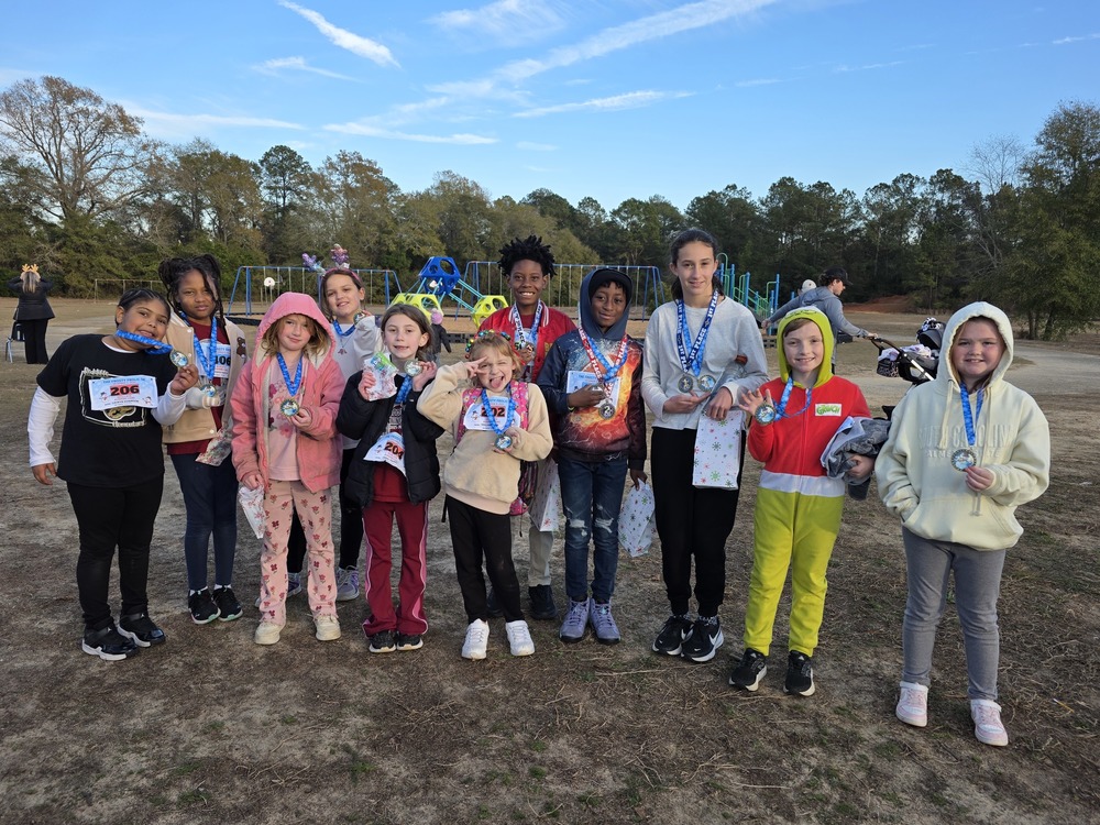 Runners holding medals.