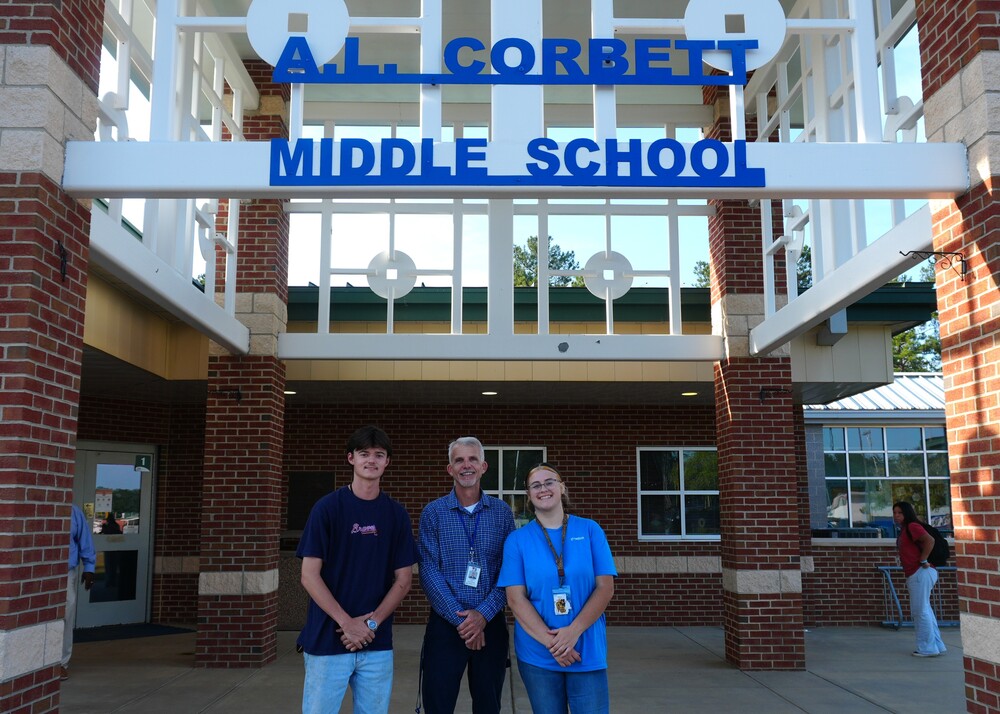 Wagener-Salley welding teacher Richard Bailey stands with two students, Robert Rodgers and Madeline Sauls with new A.L. Corbett Middle School sign.
