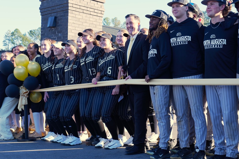 Principal Casey Rogers prepares to cut ribbon to the new stadium