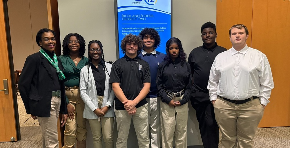 Aiken High School DECA students pose together at event.