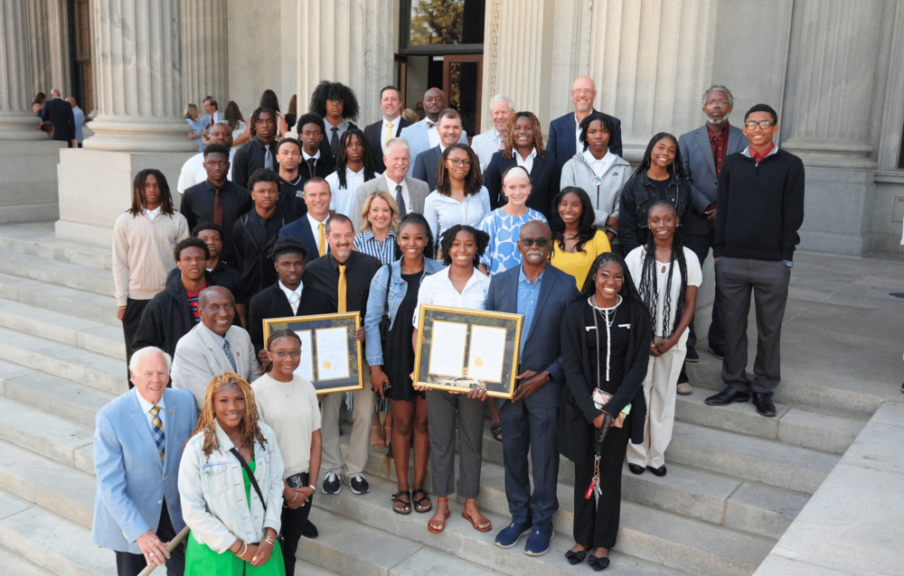 NAHS basketball teams holding house resolutions on steps of SC State House.